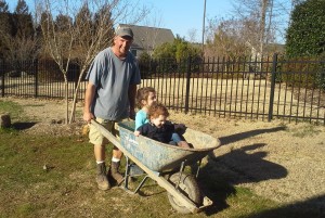 Owner Brian McCarthy and kids in wheelbarrow.