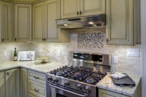 Kitchen remodel, tile, stainless steel gas range.